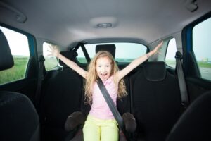 Child in the back seat of a car