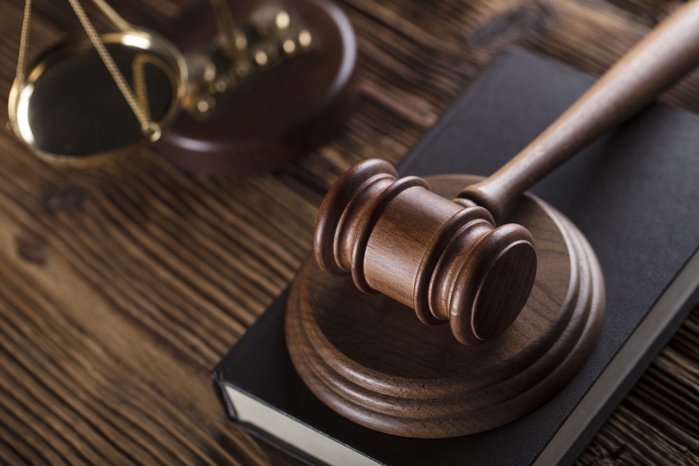 family holding photo frame in memory of loved one